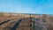 Curved sandy path to the ocean and beach lines with a wooden split rail fence and an erosion slat fence