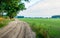 Curved sandy path with wheel tracks in a rural landscape