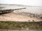 Curved seaside scene pipe groyne beach seaweed pebbles