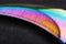 The curved sharp blade of the Kerambit Dagger is a gradient rainbow color on a dark background.