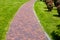 Curved stone tile pavement crescent path.