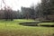 Curved stream bench in green park in winter