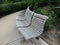 A curved timber park bench in a public park