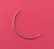 Curved upholstery cloth needle on a red paper background