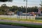 Curved white wooden fence alongside a grassy