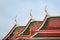 Curves on the roof of the famous buddhist temple Wat Arun with clear sky in the background