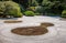 Curves, shapes and designs drawn into sand of a typical Japanese garden