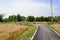 Curving countryside blacktop in wheat fields of sunny summer aft