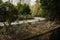 Curving countryside path by irrigation ditch in sunny winter aft