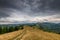 Curving dirt road on the top of the mountains in the Carpathian mountains, Romania