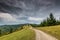 Curving dirt road on the top of the mountains in the Carpathian mountains, Romania