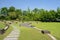 Curving flagstone path in grassy lawn on sunny summer day