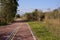 Curving footpath in countryside with snow mountain in distance