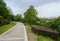 Curving footpath at lake shore in cloudy summer afternoon