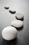 Curving Line of Grey Pebbles on Dark Background