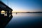 Curving lines and calm water by Tauranga Harbour Bridge and colour in the sky at sunrise