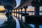 Curving lines and calm water under Tauranga Harbour Bridge at sunrise