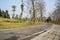 Curving mountainside asphalt road on sunny spring day