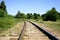 Curving rail line winds its way through trees and forests.