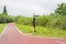 Curving red-painted path,greenway,in Lujiatan Park on cloudy summer day