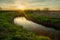 A curving river with a green shore and sunset, Stankow, Poland