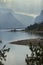Curving shoreline of Jackson Lake, sun rays, Jackson Hole, Wyomi