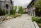 Curving stone-paved path in old-fashioned buildings on cloudy da