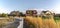 Curving white picket fence with border of grass