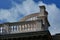 Curving white stone balustrade and railing at roof top under blue sky