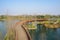 Curving wooden footbridge over water in sunny winter morning