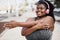 Curvy african woman stretching during workout routine outdoor at city park - Focus on face