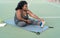 Curvy Afro woman doing stretching exercises session - Young African female having fun training outdoor