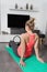 Curvy, blonde Caucasian woman practicing sport at home in a quiet and smiling way