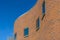 Curvy brick building exterior against blue sky