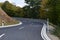 curvy Eifel road up a hill in autumn