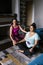 Curvy hispanic girl with instructor practicing yoga poses at home in Latin America