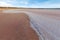 Curvy salt deposits on the beach of pink salt Lake Kenyon