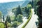 Curvy serpentine road in green mountains - beautiful panorama of Taormina, Sicily, Italy