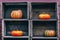 Curvy shape orange yellow farm pumpkins in wooden boxes on market shelf