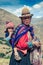 Cusco / Peru - May 29.2008: Portrait of the young peruvian woman carying the childin in the mountains