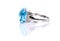 Cushion cut blue topaz ring on white background with reflection. Collection of natural gemstones accessories. Side View, Studio