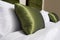 Cushions , Green pillows on bed in a hotel room