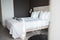 Cushions and sheets arranged on cozy bed in bedroom at luxury hotel