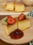 Custard cake fruits jam on wood plate