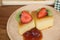 Custard cake fruits jam on wood plate