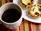 Custard tarts in a plate softfocus and black coffee cup