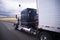 Custom big rig dark blue semi truck with reefer trailer