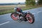 Custom bobber motorbike standing on a road.