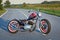 Custom bobber motorbike standing on a road.