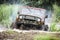 Custom built Off-road Trophy UAZ 469 leaves the swamp at high speed.